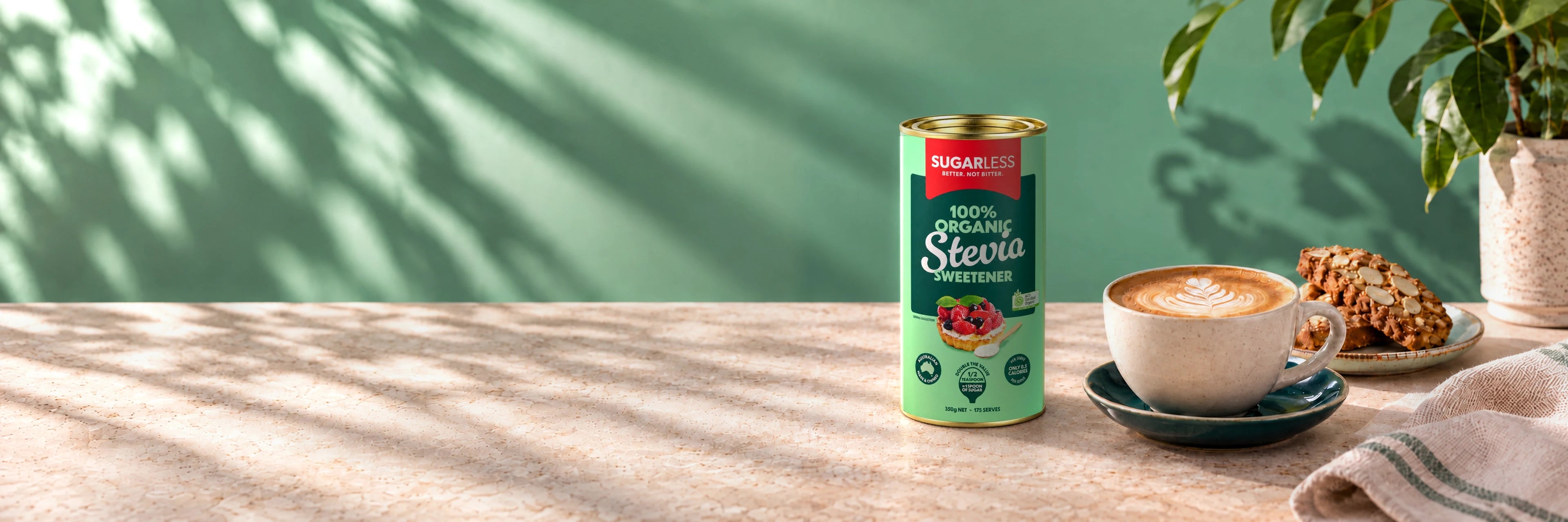 Sugarless Organic Stevia 350g standing on a sunlit stone bench beside coffee and almond biscuits